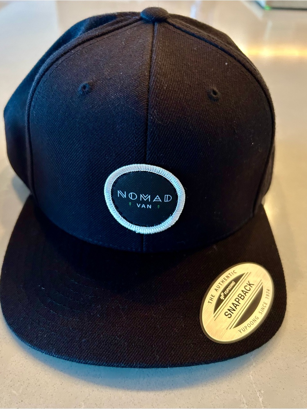 The Classic Black Snapback Hat with White Circle Patch